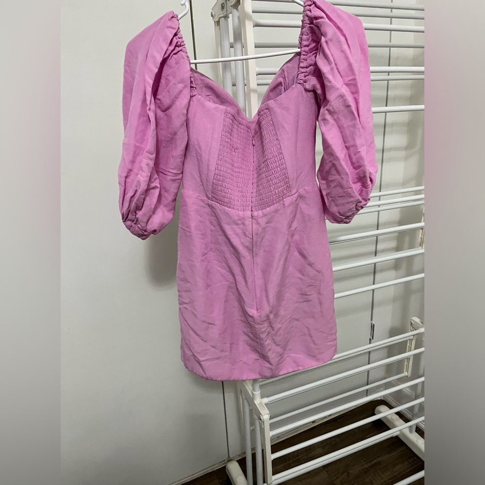 Mini dress with buttons all along the front. Off the shoulder.